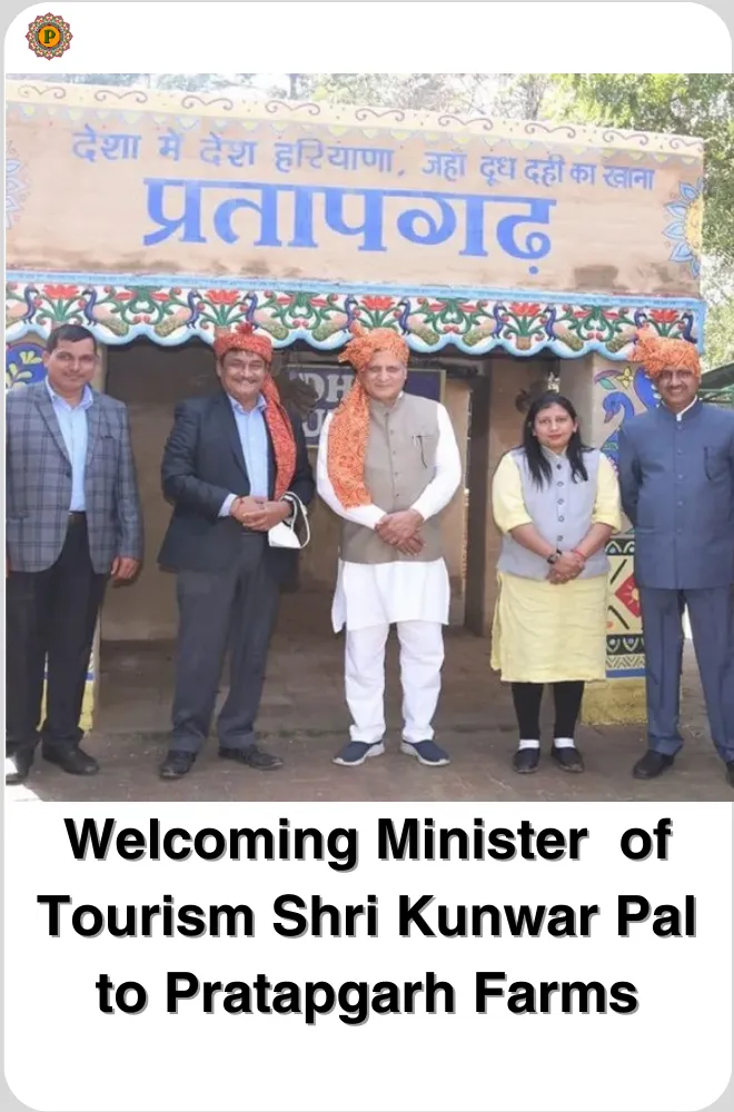 Five people in orange turbans and formal wear standing before a painted gate reading Pratapgarh