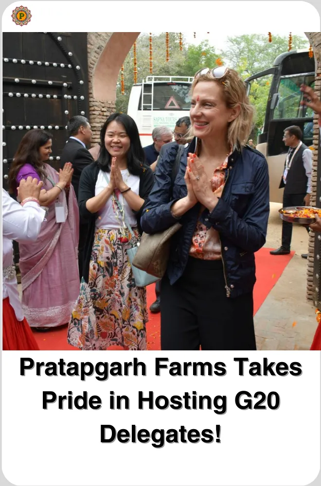 G20 visitors with folded hands greeting hosts on a red carpet beside a bus at an arched gate