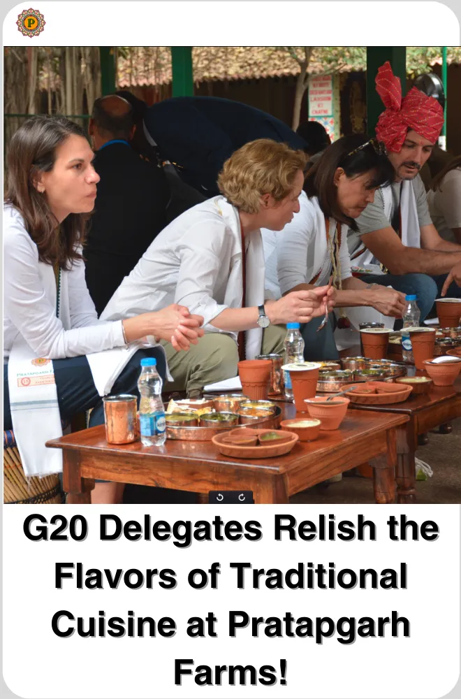 Delegates at low wooden tables eating traditional food served in clay bowls and steel plates