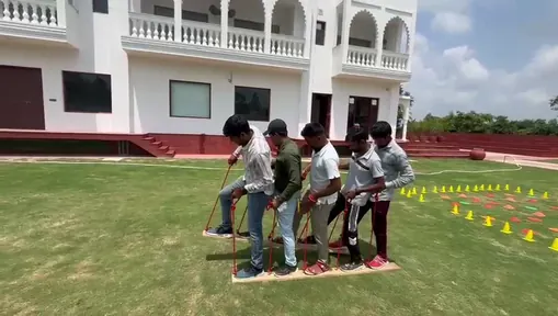 Colleagues competing in a team game on the lawns