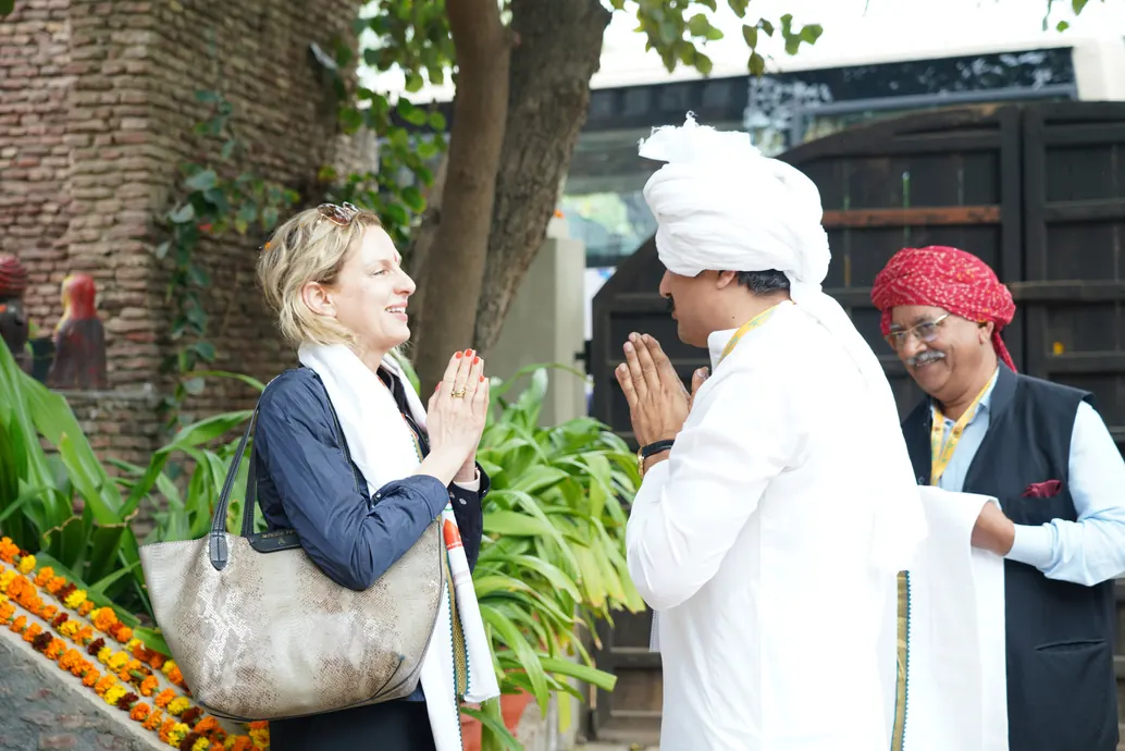 A guest being welcomed by folk artists in traditional dress
